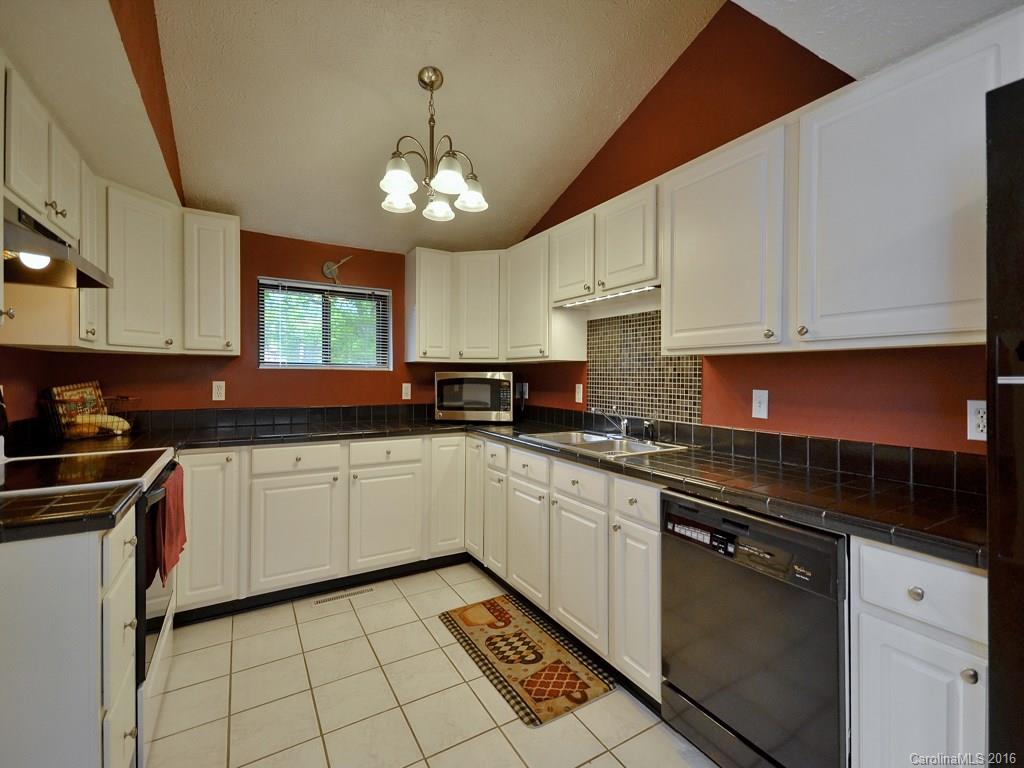 442 Thompson Cove Road Clyde, NC 28721 - Photo 6 of 20 a kitchen with stainless steel appliances granite countertop a sink stove and cabinets