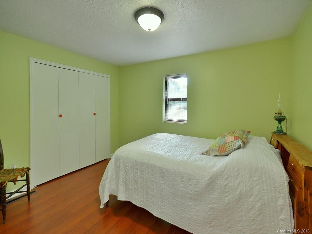442 Thompson Cove Road Clyde, NC 28721 - Photo 9 of 20 a bedroom with a bed and a potted plant