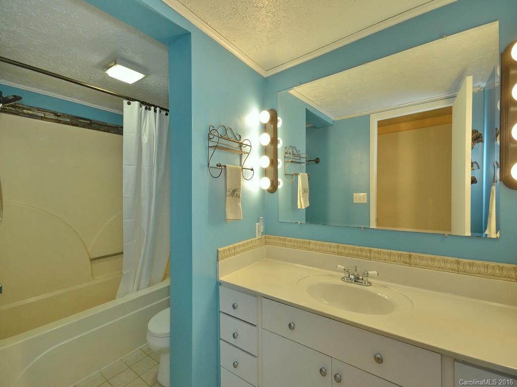 442 Thompson Cove Road Clyde, NC 28721 - Photo 10 of 20 a bathroom with a sink and a mirror