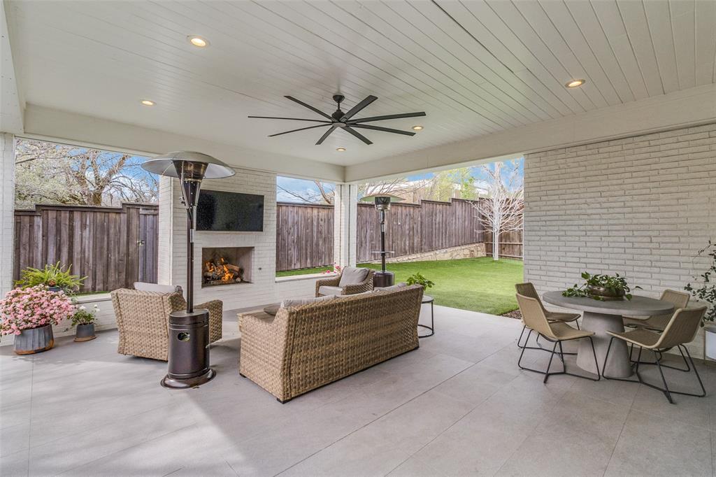 7533 Garonne Street Dallas, TX 75231 - Photo 26 of 32 a living room with furniture fireplace and a flat screen tv