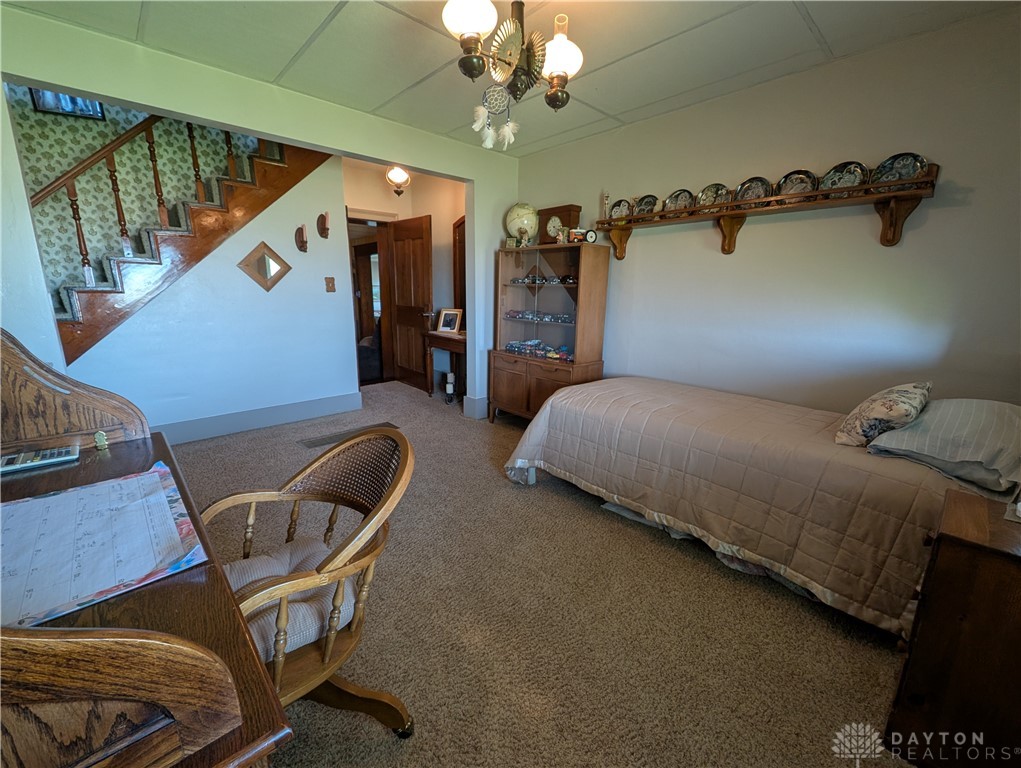 8713 Oakes Road Arcanum, OH 45304 - Photo 22 of 29 This versatile space offers comfort and convenience with a carpeted floor and classic wood staircase.