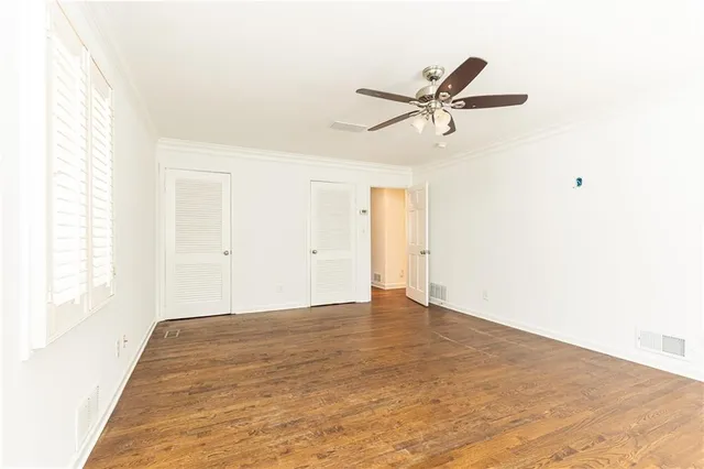 a view of a room with a window and a ceiling fan