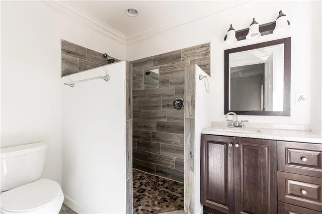 a bathroom with a toilet a sink and mirror