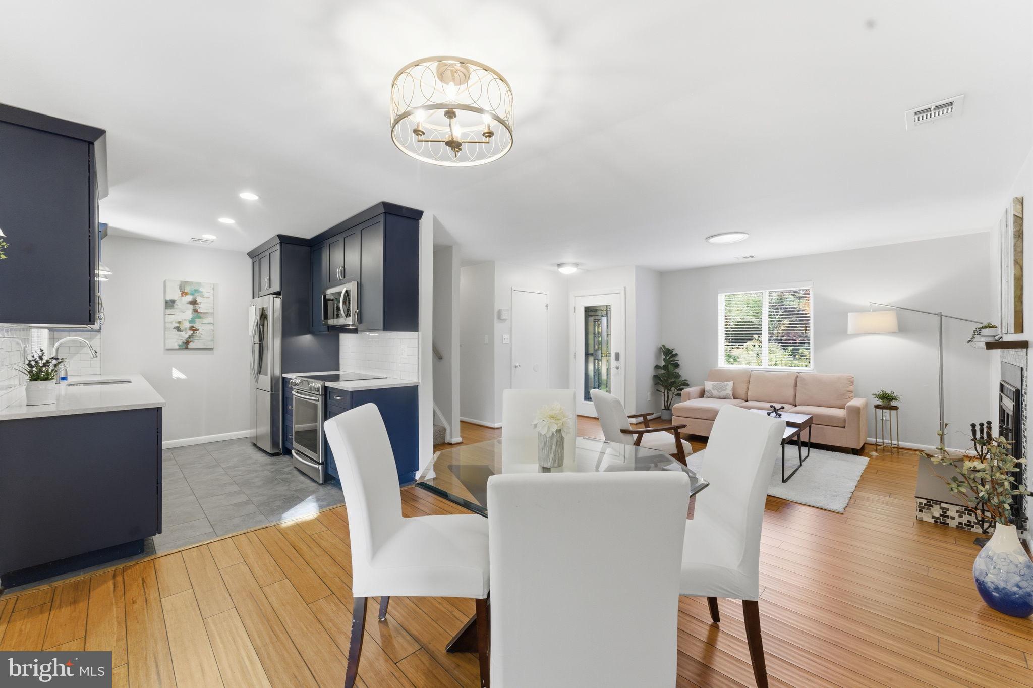 11309 Gatesborough Lane Reston, VA 20191 - Photo 14 of 85 a living room with furniture kitchen view and a wooden floor