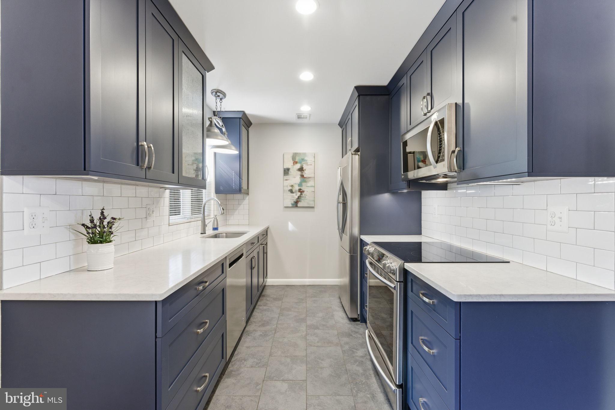 11309 Gatesborough Lane Reston, VA 20191 - Photo 15 of 85 a kitchen with granite countertop stainless steel appliances a sink stove top oven and refrigerator