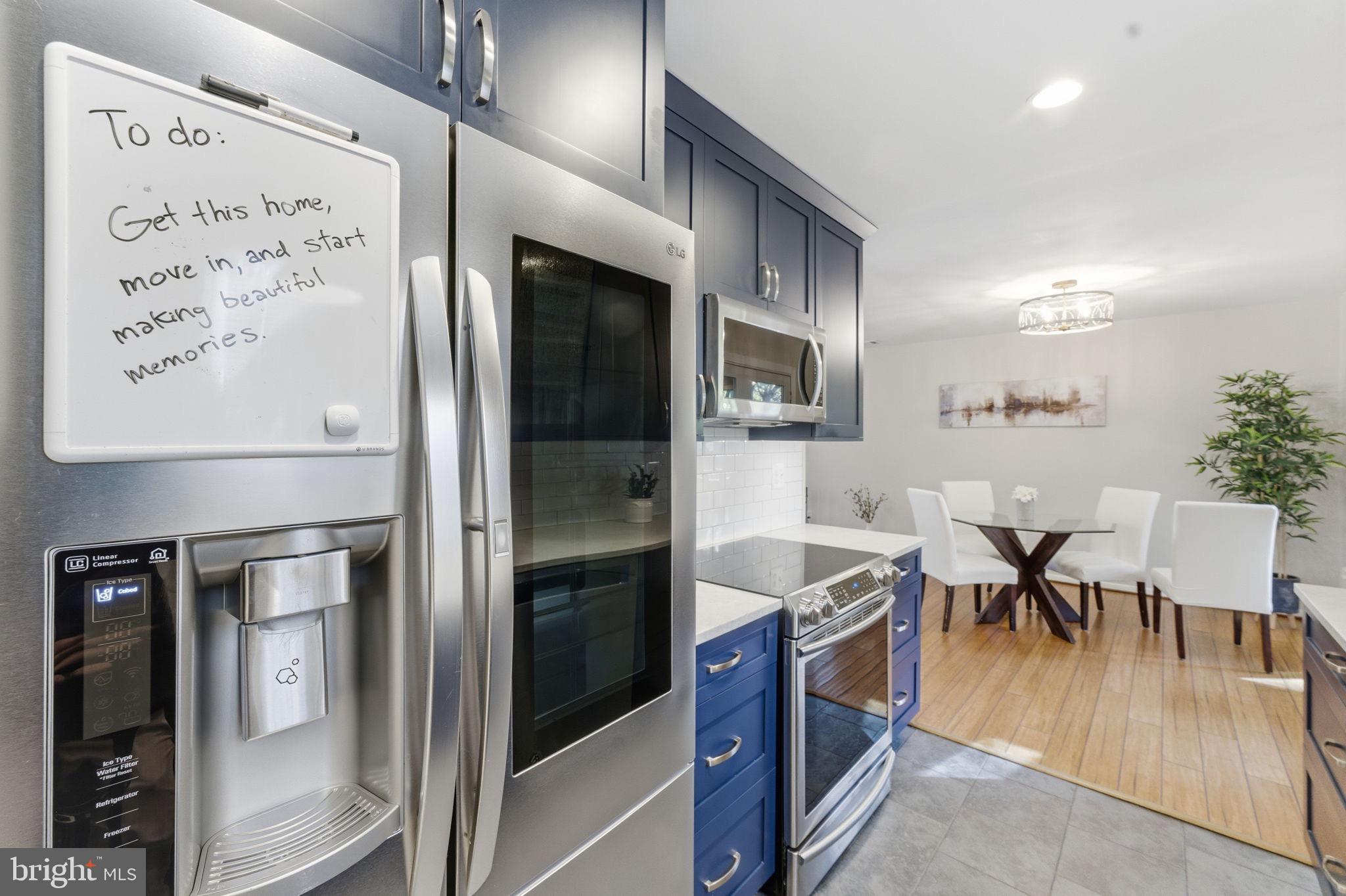 11309 Gatesborough Lane Reston, VA 20191 - Photo 19 of 85 a kitchen with stainless steel appliances granite countertop a refrigerator and a dining table