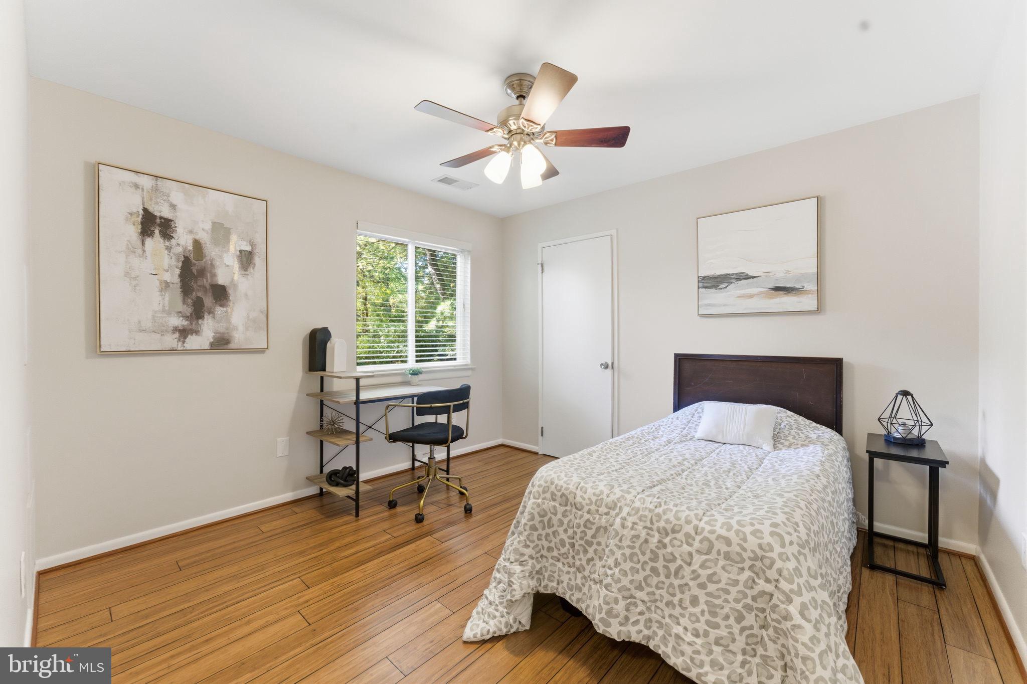 11309 Gatesborough Lane Reston, VA 20191 - Photo 28 of 85 a bedroom with a bed and a chandelier