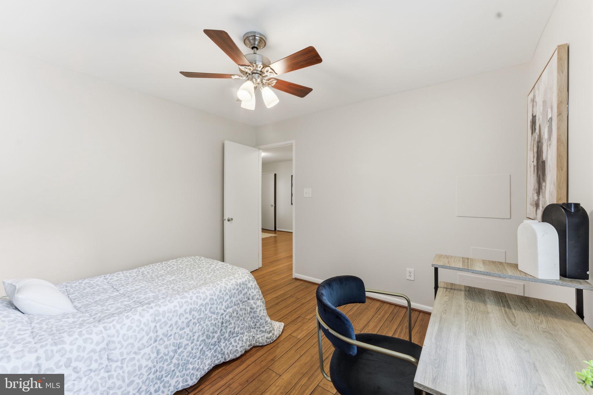 11309 Gatesborough Lane Reston, VA 20191 - Photo 29 of 85 a bedroom with a bed and a chandelier