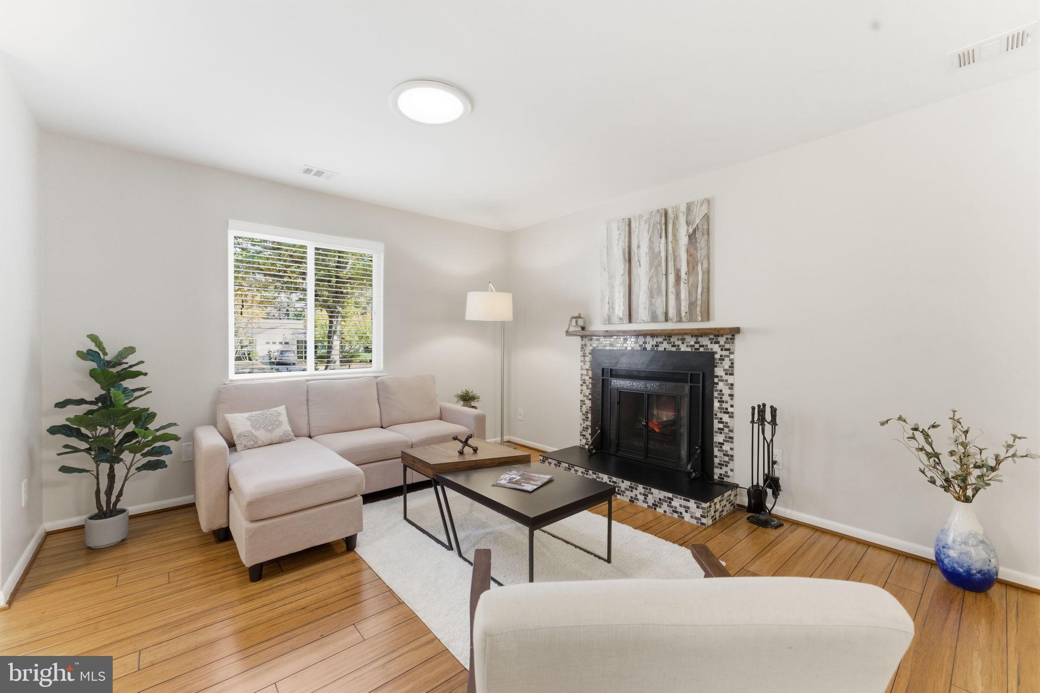 11309 Gatesborough Lane Reston, VA 20191 - Photo 8 of 85 a living room with furniture and a fireplace