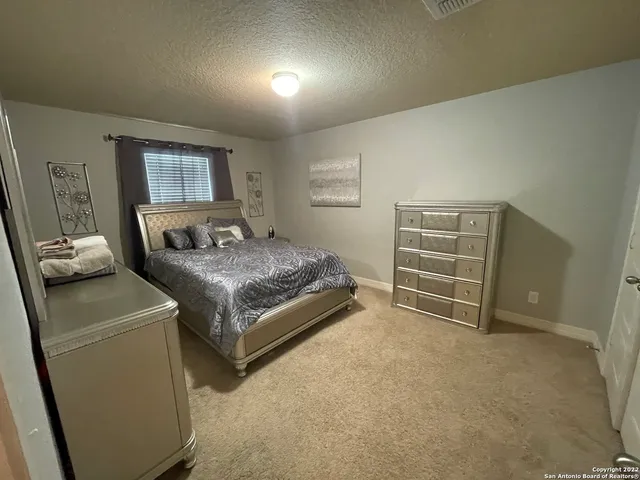 a living room with a couch and a stove next to a window