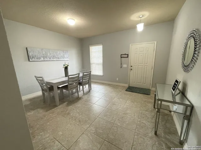 a dining room with furniture and a chandelier