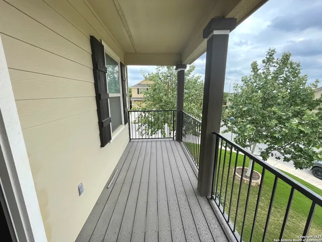 a view of a balcony with wooden floor