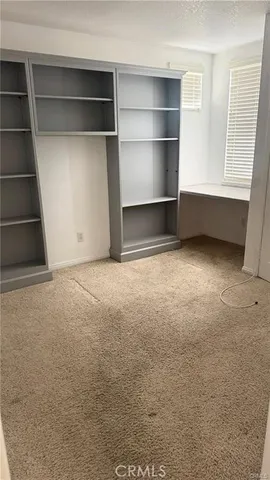 a view of an empty room with a fireplace