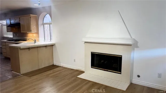 a kitchen with granite countertop a stove and a fireplace