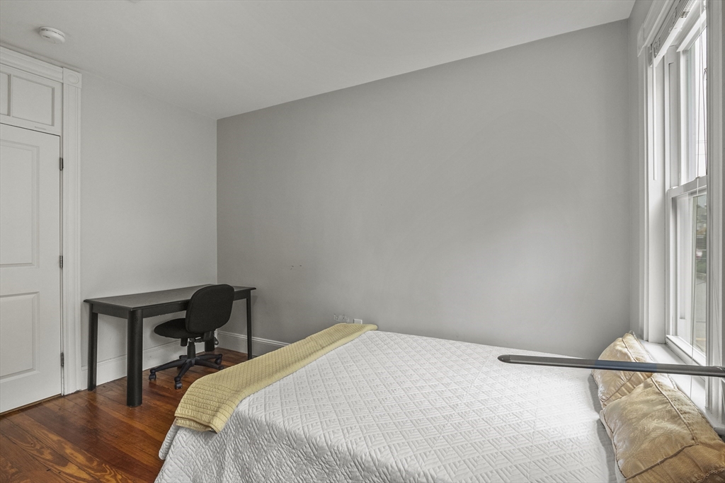 139 Adams Street, Unit 3 Waltham, MA 02453 - Photo 11 of 17 a bedroom with a bed and a window