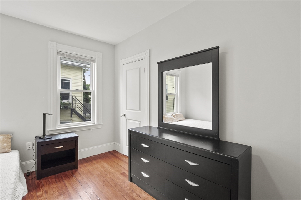139 Adams Street, Unit 3 Waltham, MA 02453 - Photo 12 of 17 a room with a dresser and a window