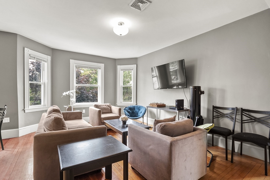 139 Adams Street, Unit 3 Waltham, MA 02453 - Photo 2 of 17 a living room with furniture and a flat screen tv