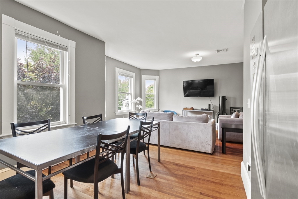 139 Adams Street, Unit 3 Waltham, MA 02453 - Photo 3 of 17 a view of a dining room with furniture window and wooden floor