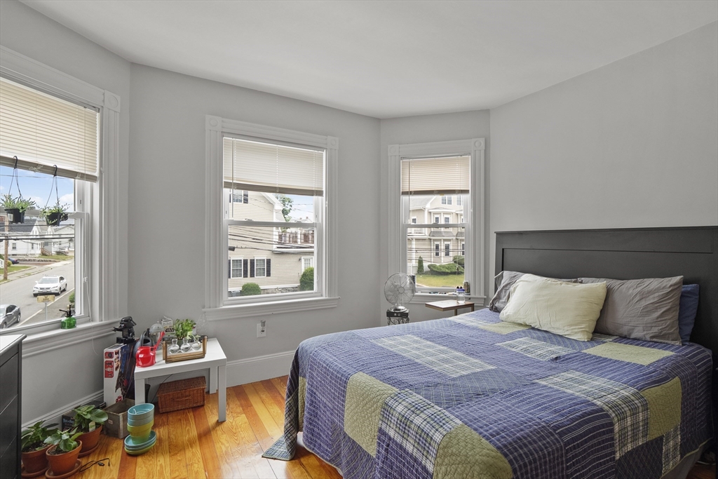 139 Adams Street, Unit 3 Waltham, MA 02453 - Photo 6 of 17 a bedroom with a bed and a window