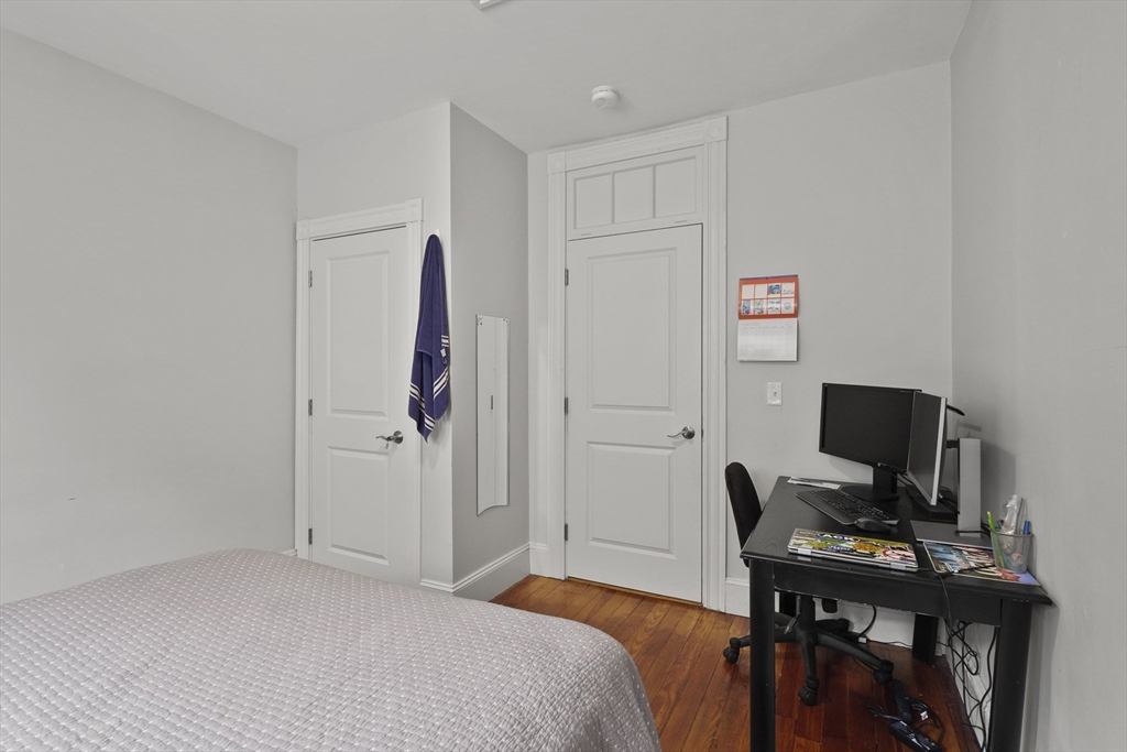 139 Adams Street, Unit 3 Waltham, MA 02453 - Photo 9 of 17 a view of a workspace with furniture and wooden floor