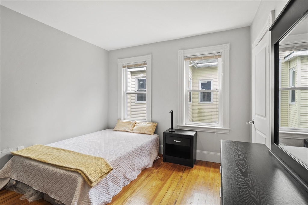 139 Adams Street, Unit 3 Waltham, MA 02453 - Photo 10 of 17 a bedroom with a bed and a large window