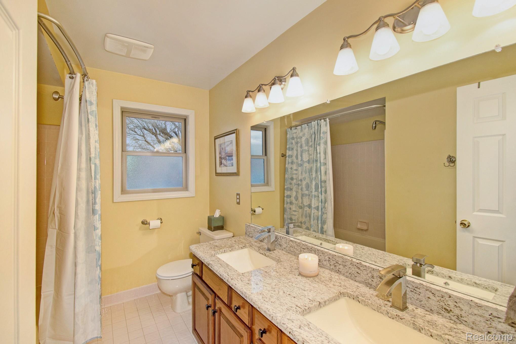 16349 Judiciary Road Macomb, MI 48044 - Photo 12 of 15 The full bathroom has been updated with granite countertops, new sinks and stylish faucets.