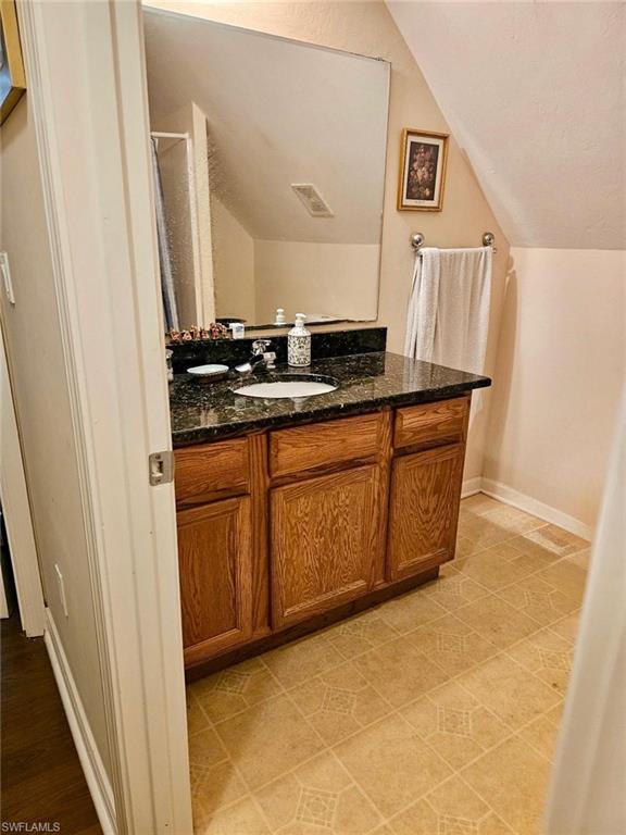 199 Leawood Circle Naples, FL 34104 - Photo 13 of 21 a bathroom with a sink and a mirror