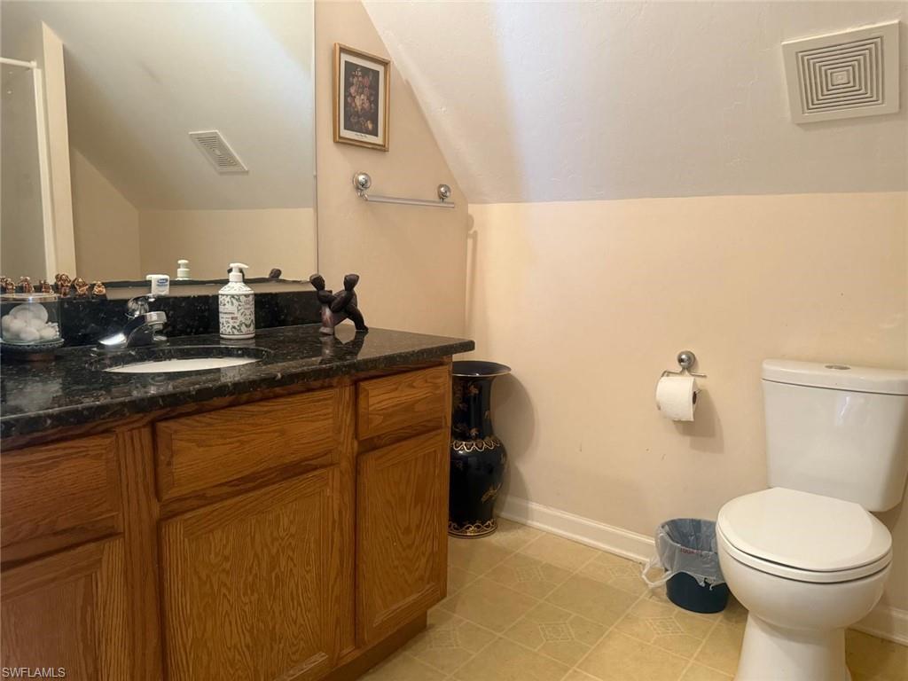 199 Leawood Circle Naples, FL 34104 - Photo 16 of 21 a bathroom with a sink a toilet and mirror