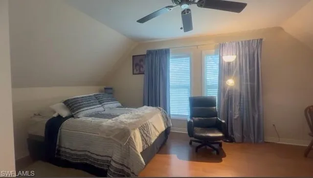 a bedroom with a bed and a chair