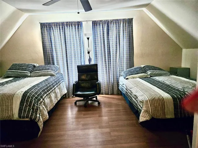 a bedroom with a bed a chair and the outer view