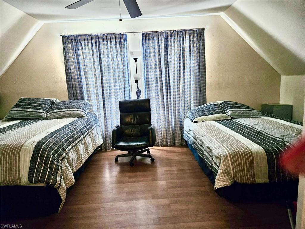 199 Leawood Circle Naples, FL 34104 - Photo 18 of 21 a bedroom with a bed a chair and the outer view