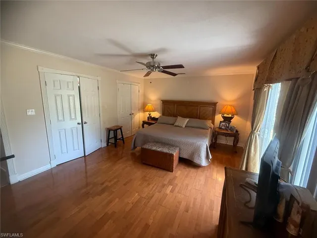 a bedroom with furniture and a wooden floor