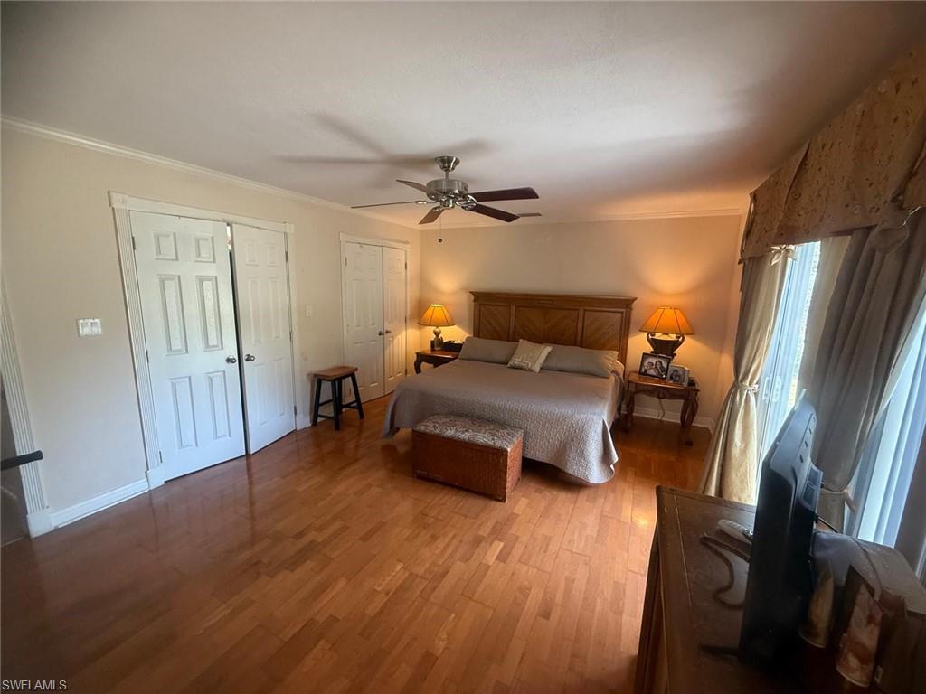 199 Leawood Circle Naples, FL 34104 - Photo 19 of 21 a bedroom with furniture and a wooden floor