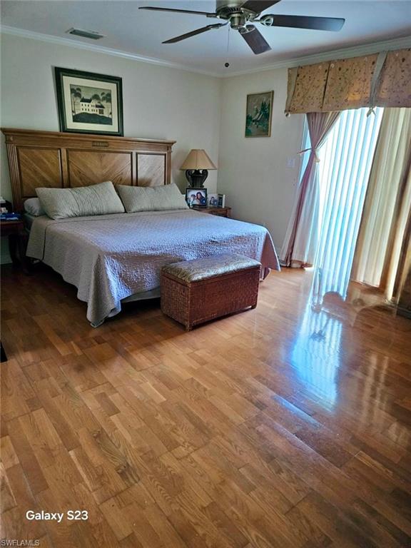 199 Leawood Circle Naples, FL 34104 - Photo 3 of 21 a bedroom with a bed and wooden floor