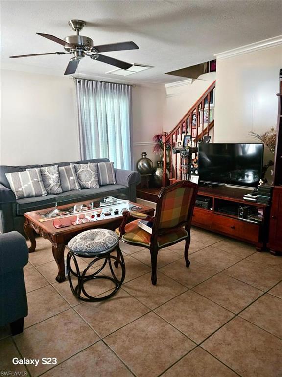199 Leawood Circle Naples, FL 34104 - Photo 7 of 21 a living room with furniture and a projector