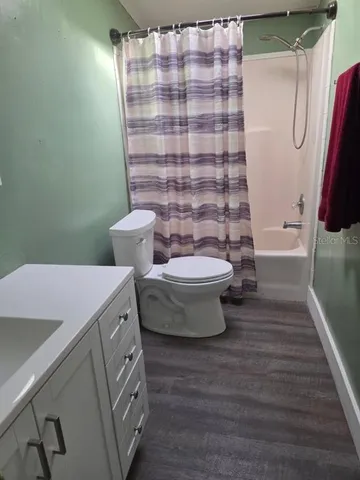 a view of a bathroom with bathtub and shower