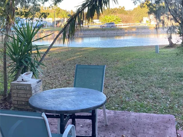 a view of a backyard with a garden and outdoor seating