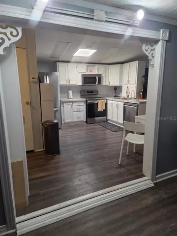 a kitchen with stainless steel appliances granite countertop a refrigerator and microwave