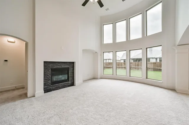 a large white kitchen with granite countertop a large window and a sink