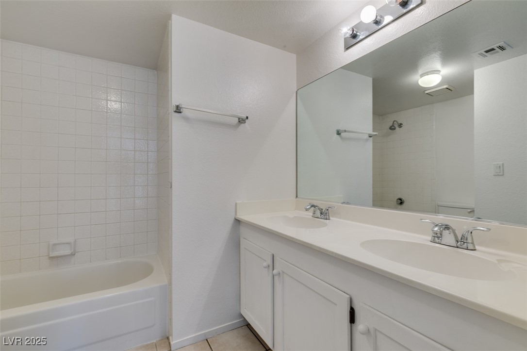 2681 Ruthe Duarte Avenue Las Vegas, NV 89121 - Photo 37 of 43 Bathroom featuring a sink, visible vents, tile patterned floors, and bathtub / shower combination