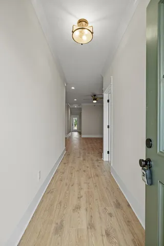 a view of a hallway with wooden floor