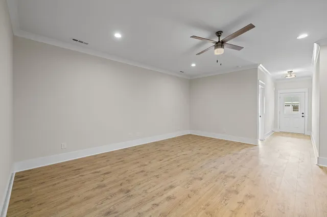a view of kitchen with kitchen island white cabinets and refrigerator
