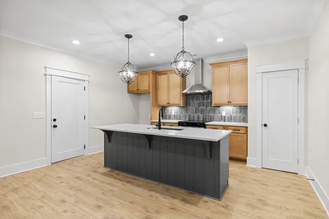 a kitchen with a sink a center island and stainless steel appliances