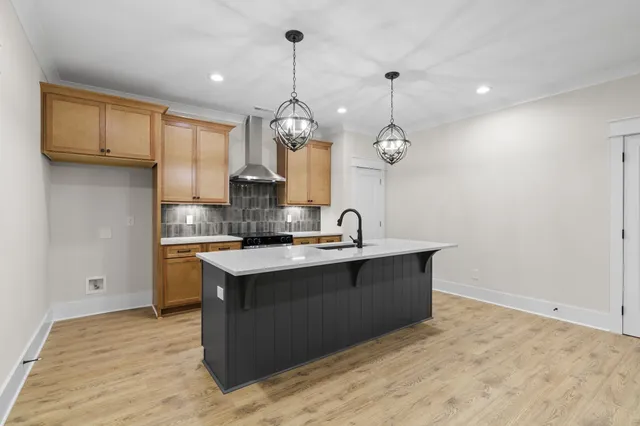 a kitchen with kitchen island a sink stainless steel appliances and cabinets