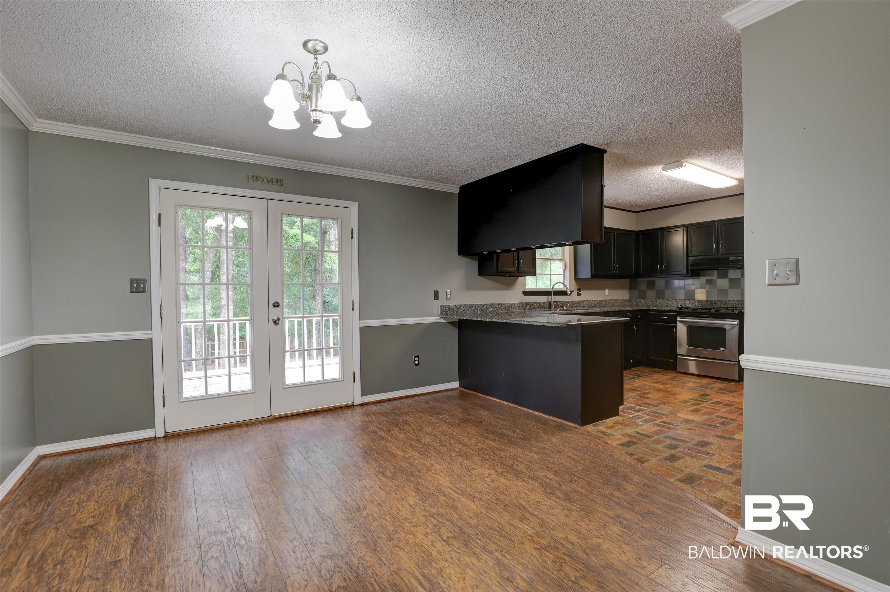492 Ridgewood Drive Daphne, AL 36526 - Photo 5 of 17 Kitchen with hardwood / wood-style floors, kitchen peninsula, range, and backsplash
