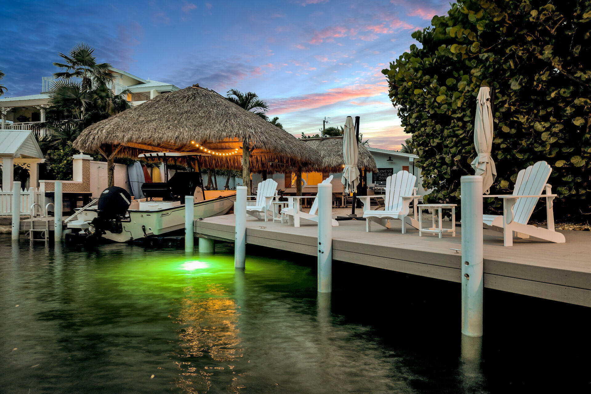a view of swimming pool with lawn chairs and a yard