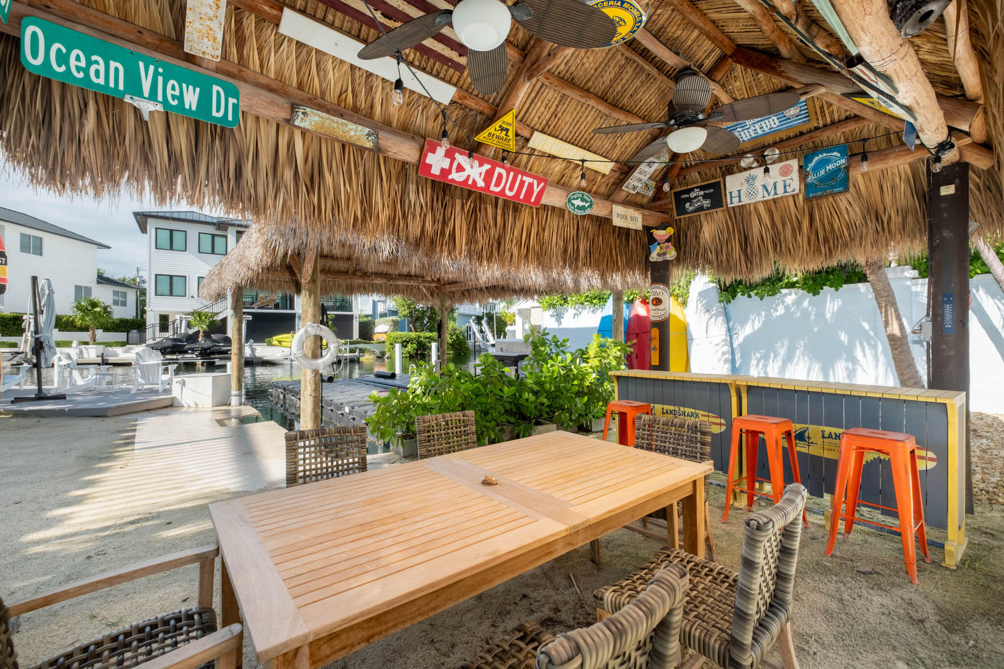 181 Ocean View Drive Key Largo, FL 33037 - Photo 18 of 52 a view of a patio with table and chairs potted plants