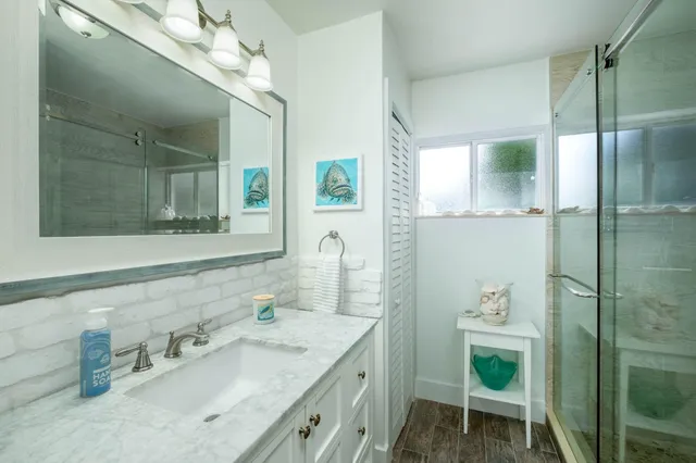 a bathroom with a granite countertop sink a toilet and a mirror