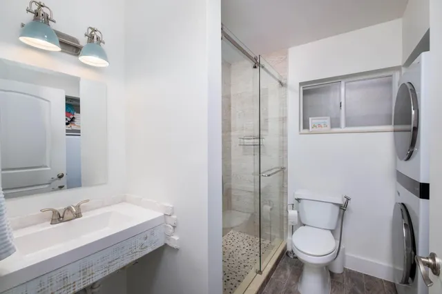 a bathroom with a sink toilet and shower