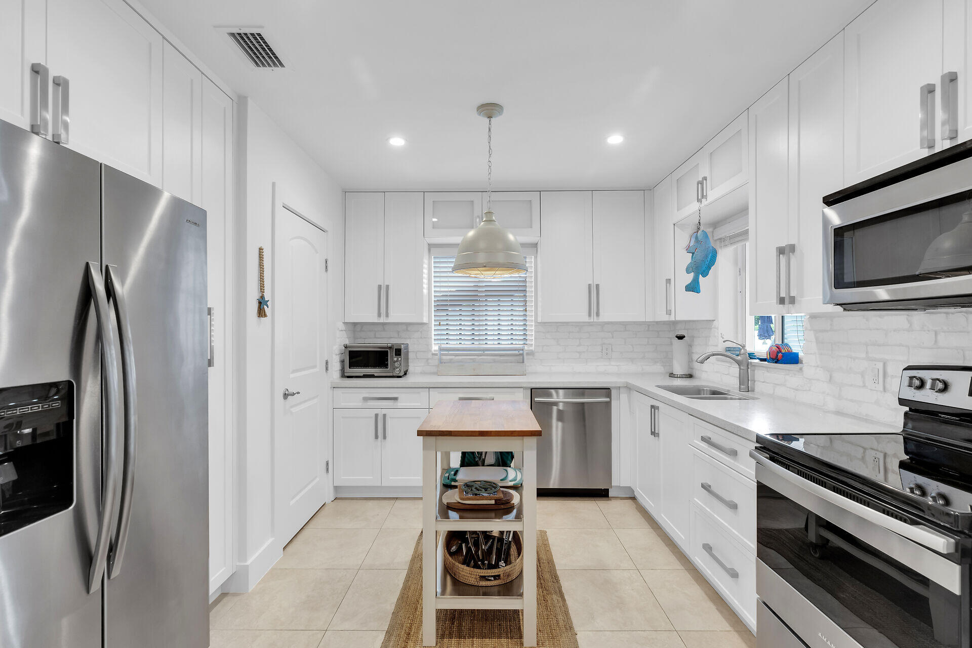 181 Ocean View Drive Key Largo, FL 33037 - Photo 31 of 52 a kitchen with stainless steel appliances a stove sink and refrigerator